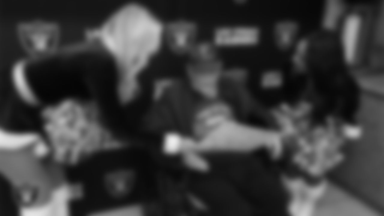 Raiderettes Kennedy and Cierra speak to a veteran during the annual Cox Salute to Service Tailgate at Southern Nevada State Veterans Home.