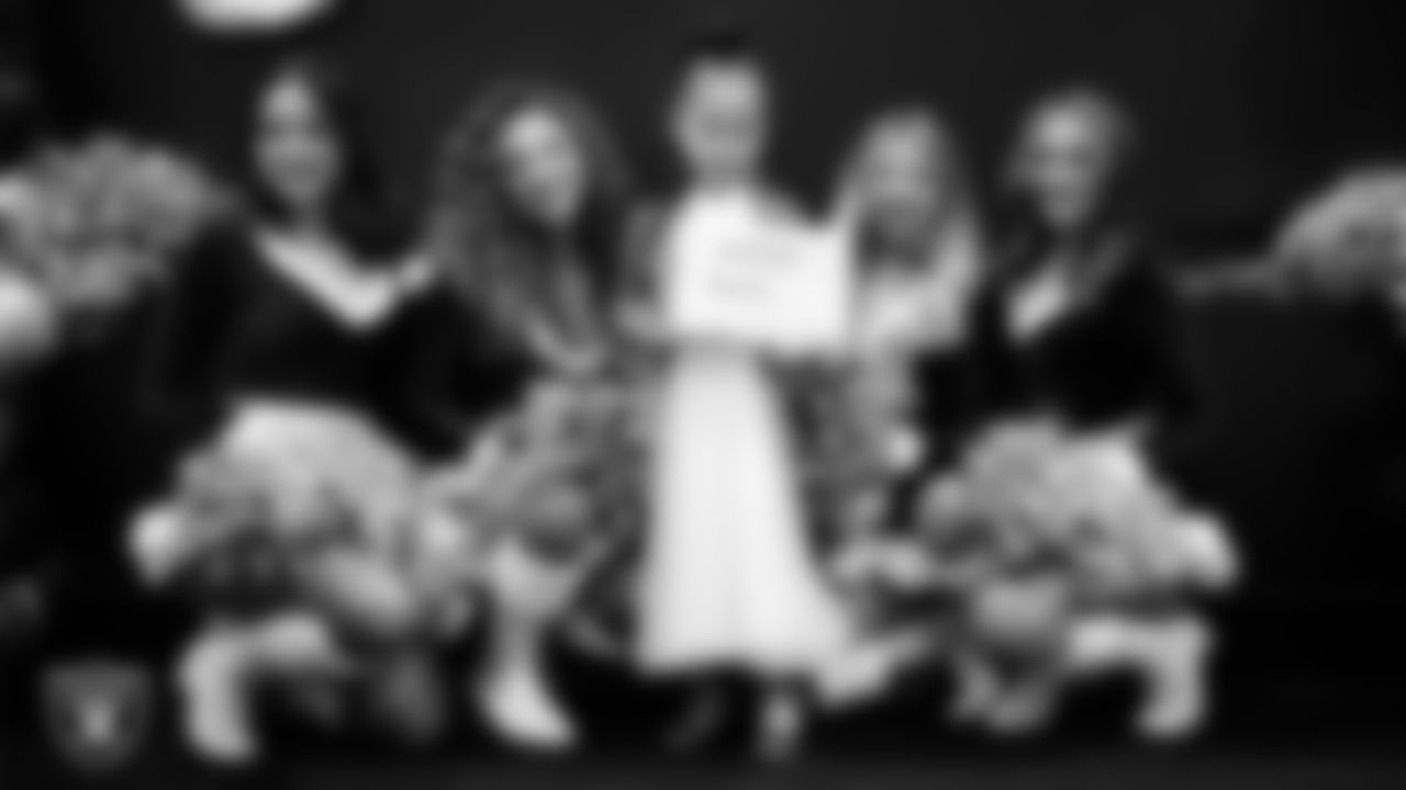 Raiderettes pose for a photo with a Junior Raiderette during the Junior Raiderettes Banquet at The Studio.