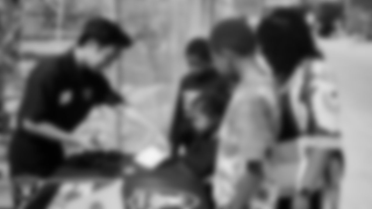 Guests receive a map during a Las Vegas Raiders library card launch event at The Lion Habitat Ranch.