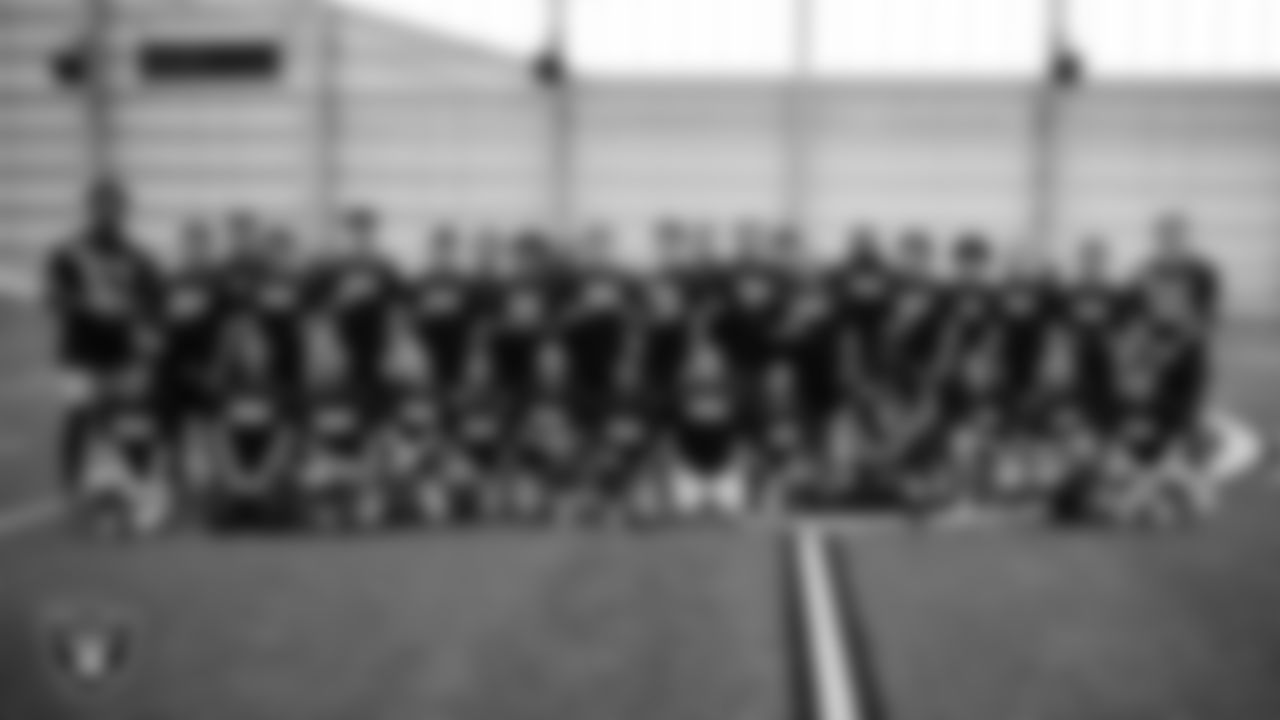 Las Vegas Raiders linebacker Amari Gainer (53), wide receiver Dont'e Thornton Jr. (10) and linebacker Cody Lindenberg (55) pose for a photo with Green Valley High School athletes at a skills camp during Play Football Day at Intermountain Health Performance Center.