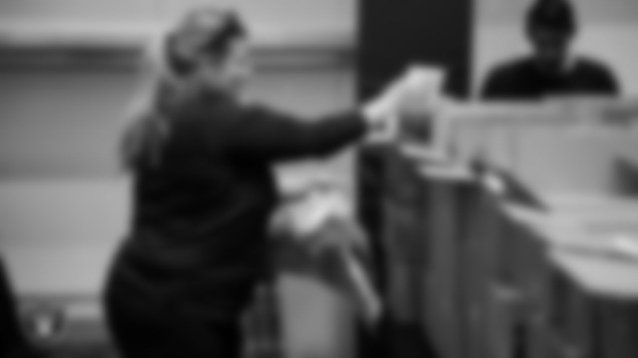 Las Vegas Raiders staff members help pack meals during the Raiders Holiday Meal Packing Party at Intermountain Health Performance Center.