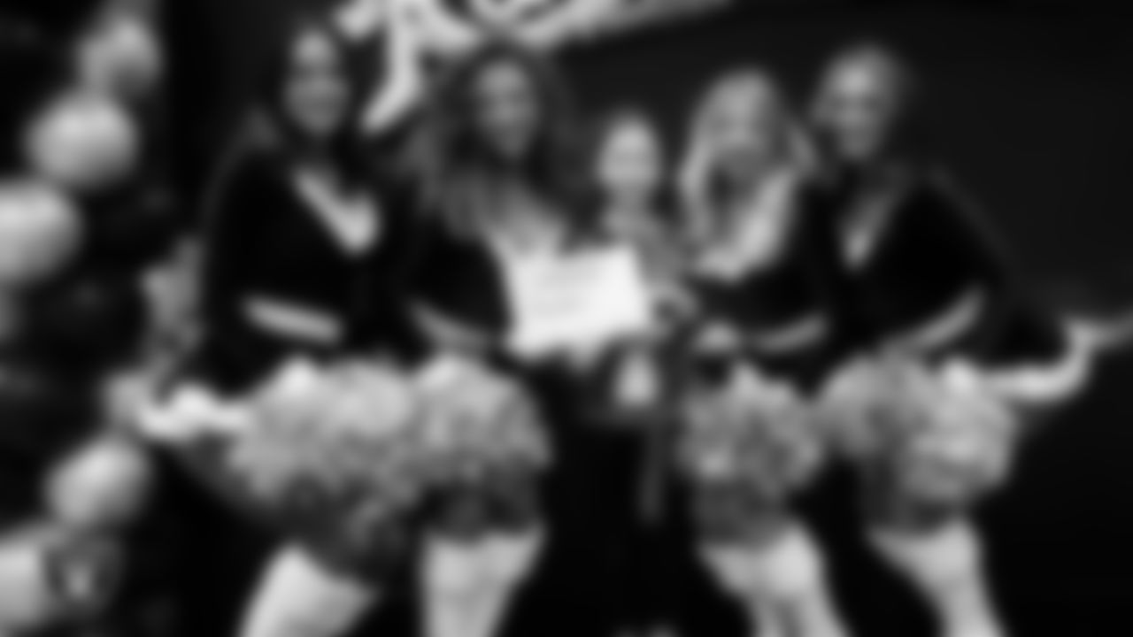 Raiderettes pose for a photo with a Junior Raiderette during the Junior Raiderettes Banquet at The Studio.