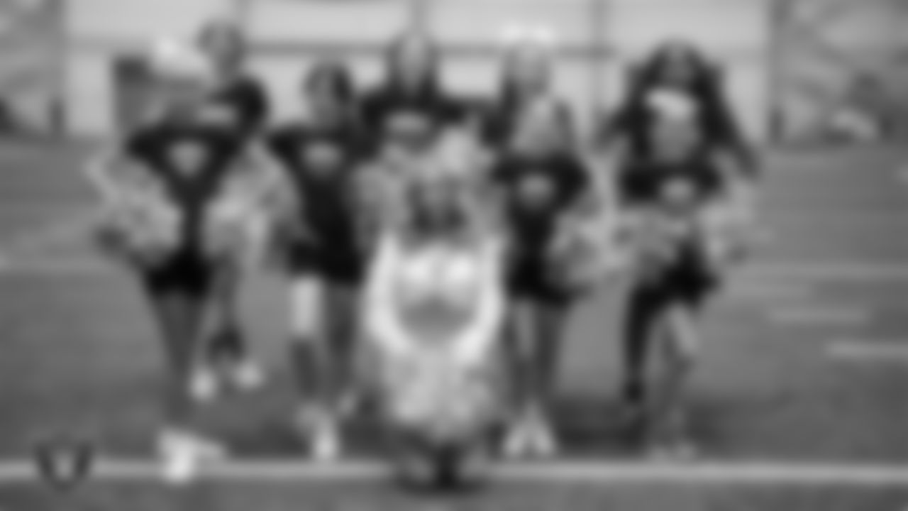 Raiderette Taylor poses for a photo with dancers during day three of summer camp at Intermountain Health Performance Center.