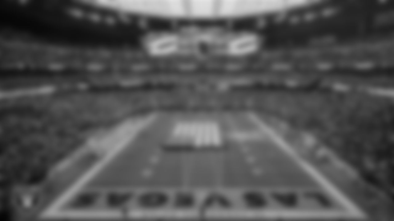 The American flag is displayed by Personal Seat License (PSL) holders on the field during the national anthem before the Las Vegas Raiders' regular season home game against the Kansas City Chiefs at Allegiant Stadium.
