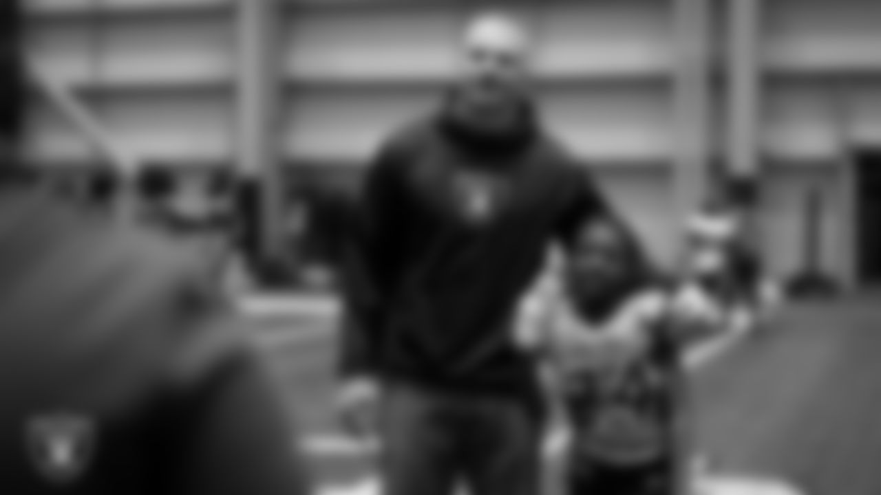 Las Vegas Raiders linebacker Tommy Eichenberg (44) poses for a photo with an athlete during an open practice at Intermountain Health Performance Center.