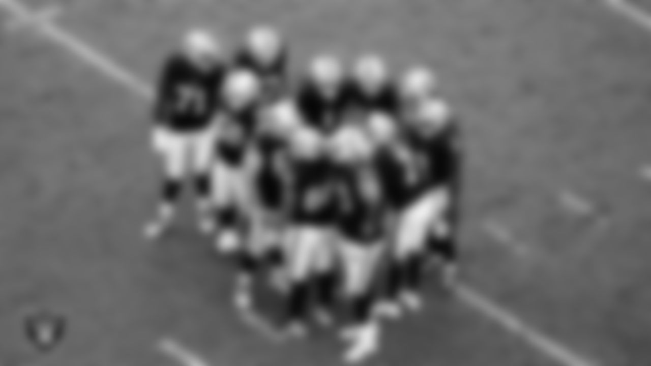 The Las Vegas Raiders offense huddles during the regular season home game against the Tennessee Titans at Allegiant Stadium.
