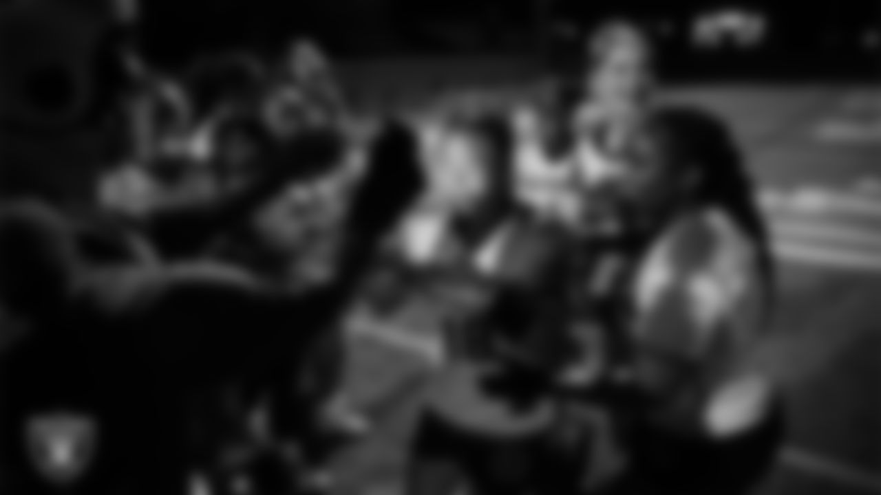 Raider Rusher presents Las Vegas High School wide receiver/linebacker/defensive back Lissette Do (18) with the MVP chain after winning the Las Vegas Raiders' High School Flag Football Showcase game at Mater East Academy.