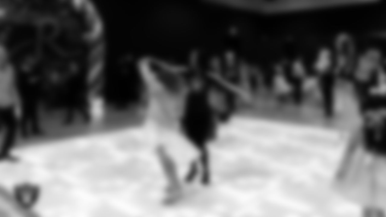 Raiderette Reagan dances with attendees during the Valentine's Day Dance at The Studio.