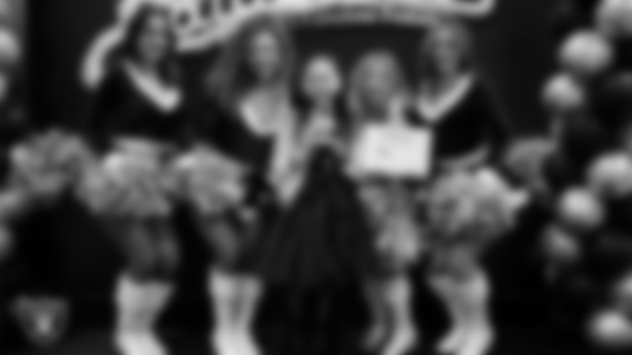 Raiderettes pose for a photo with a Junior Raiderette during the Junior Raiderettes Banquet at The Studio.