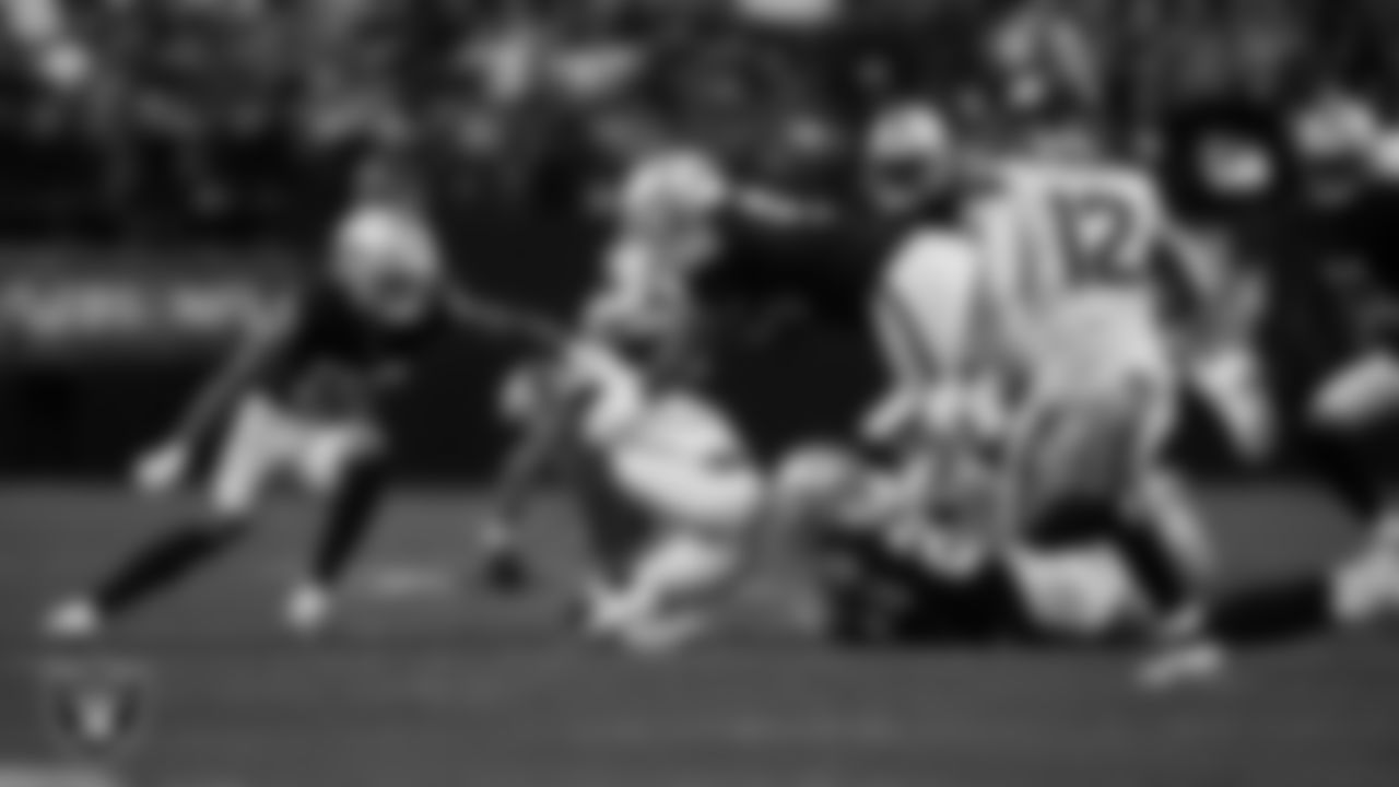 Las Vegas Raiders safety Isaiah Pola-Mao (20) and defensive tackle Jonah Laulu (96) go to make a tackle during the regular season home game against the Denver Broncos at Allegiant Stadium.