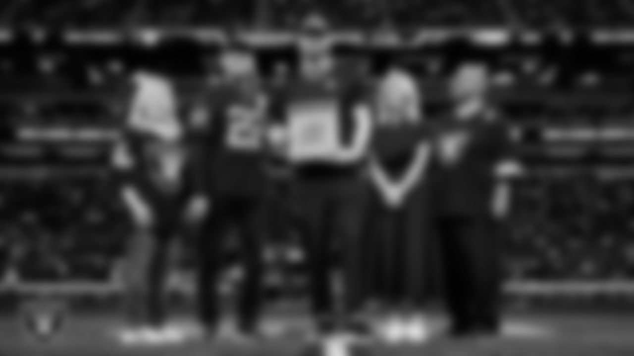 Las Vegas Raiders defensive end Maxx Crosby (98) is awarded the Commitment to Excellence Award on the field before the regular season home game against the Kansas City Chiefs at Allegiant Stadium.