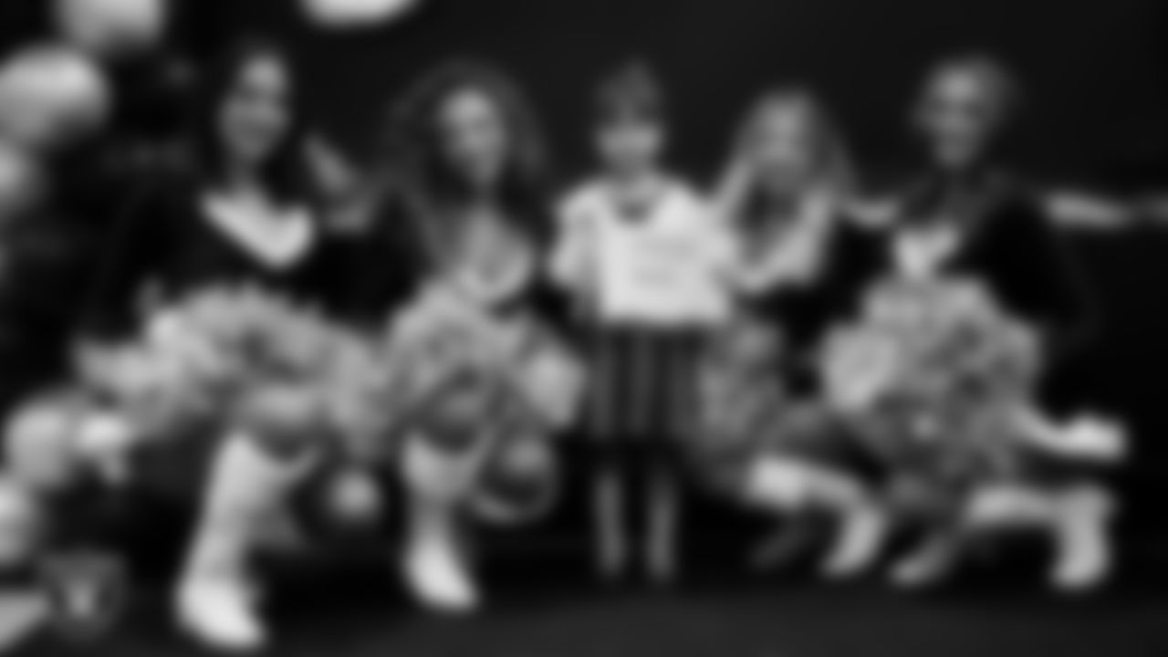 Raiderettes pose for a photo with a Junior Raiderette during the Junior Raiderettes Banquet at The Studio.