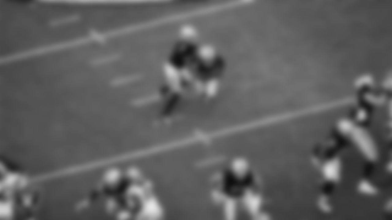 Las Vegas Raiders quarterback Geno Smith (7) hands the ball off to running back Ashton Jeanty (2) during the preseason home game against the San Francisco 49ers at Allegiant Stadium.