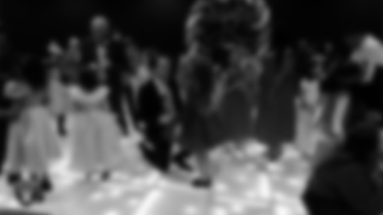 Attendees exchange roses during the Valentine's Day Dance at The Studio.