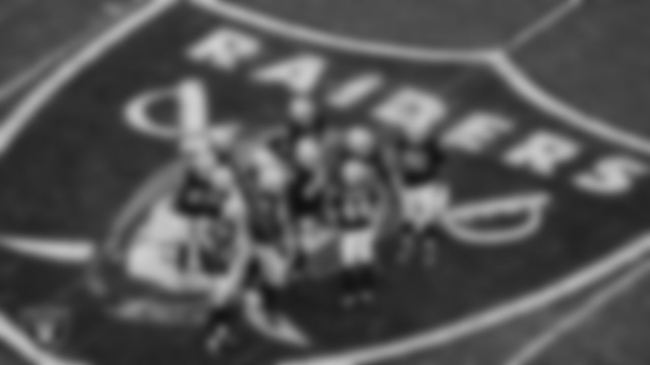 The Las Vegas Raiders defense huddles during the regular season home game against the Kansas City Chiefs at Allegiant Stadium.