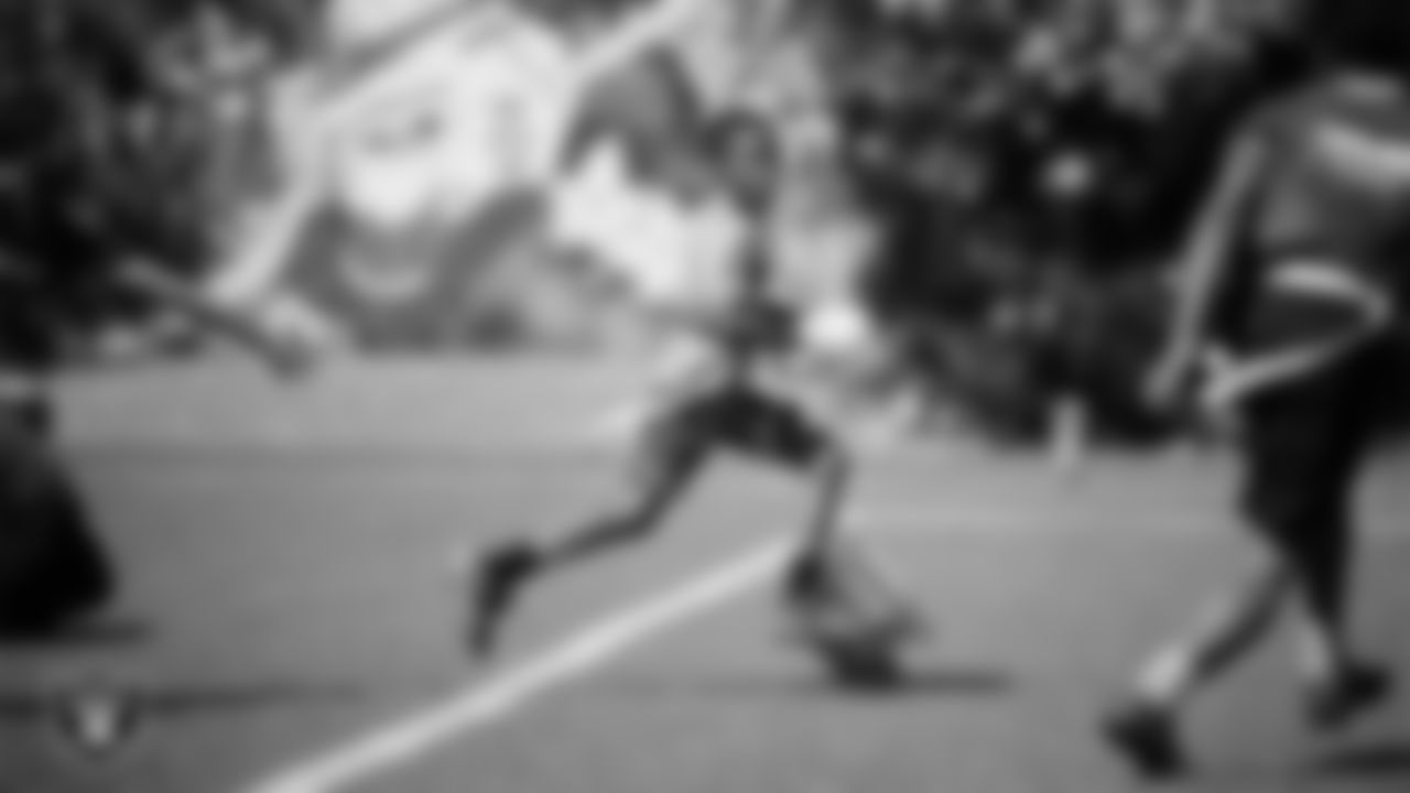 An athlete competes in a Silver and Black Flag Football game at Bill and Lillie Heinrich YMCA.