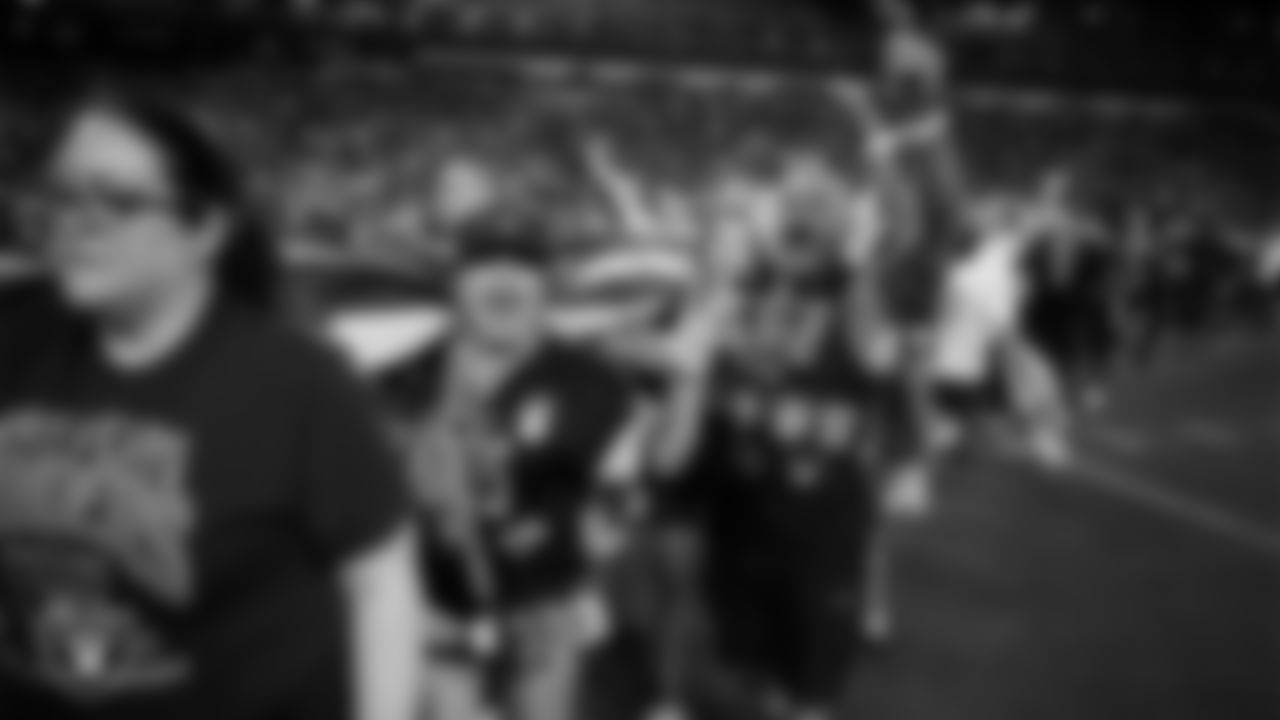 The American flag is displayed by Personal Seat License (PSL) holders on the field after the national anthem before the Las Vegas Raiders' regular season home game against the Los Angeles Chargers at Allegiant Stadium.