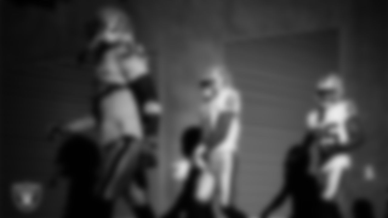 Las Vegas Raiders cornerback Darnay Holmes (30), safety Jeremy Chinn (11) and cornerback Decamerion Richardson (25) walk down the tunnel before the regular season away game against the Indianapolis Colts at Lucas Oil Stadium.