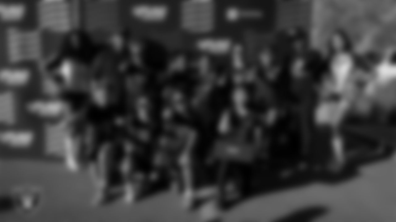 Raiderettes Shayla and Meekela pose for a photo with the Conquer Chargers 10U Girls flag football team after they won a 2025 NFL FLAG Regional Tournament game at Heritage Park.