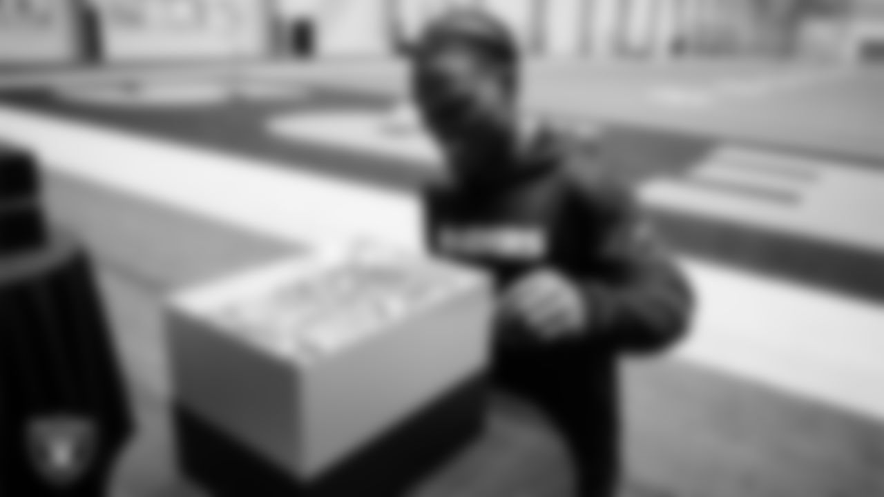Las Vegas Raiders cornerback Darnay Holmes (30) unboxes his custom cleats for the NFL's My Cause My Cleats initiative at Intermountain Health Performance Center.