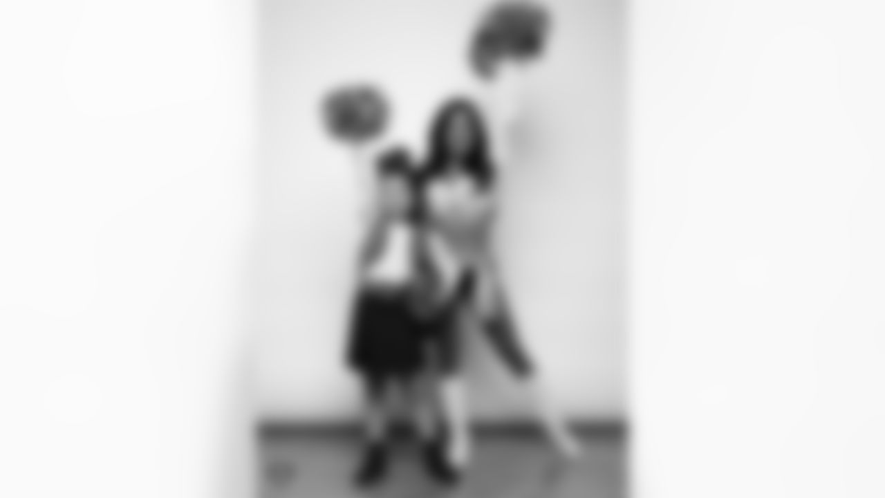 Raiderette Tatiana poses for a photo with a Junior Raiderette during 2025 Media Day at The Studio.