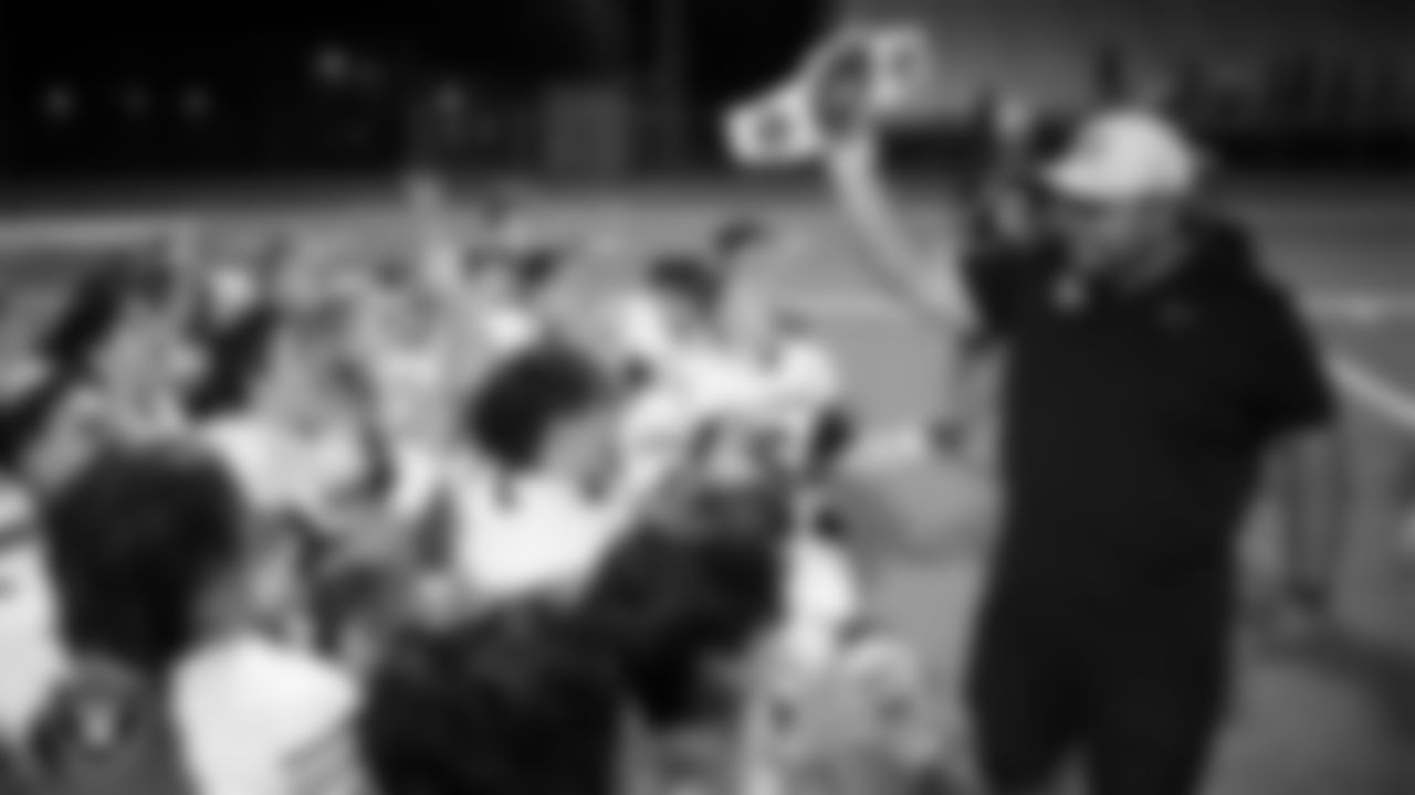 Las Vegas Raiders senior manager of football development Jordan Aguilar presents the championship belt to Carson High School after the Raiders' Football Showcase Game at Canyon Springs High School.