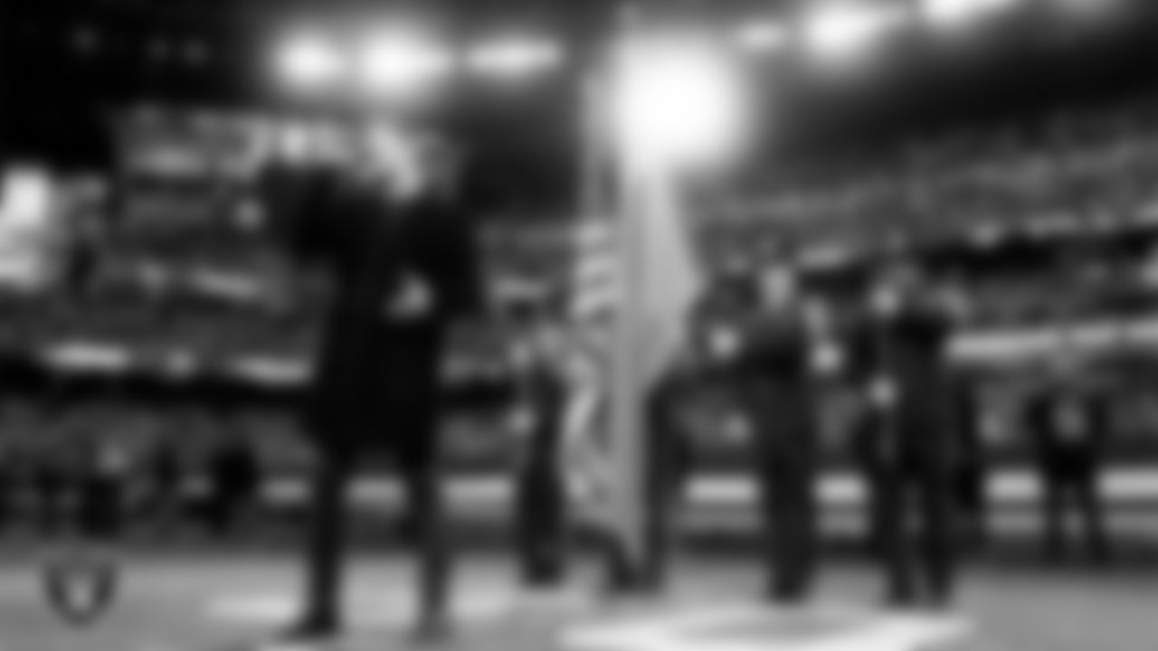 Singer Daniel Emmet performs the national anthem while the Henderson Fire Department Honor Guard presents the nation's colors before the Las Vegas Raiders' regular season home game against the Kansas City Chiefs at Allegiant Stadium.