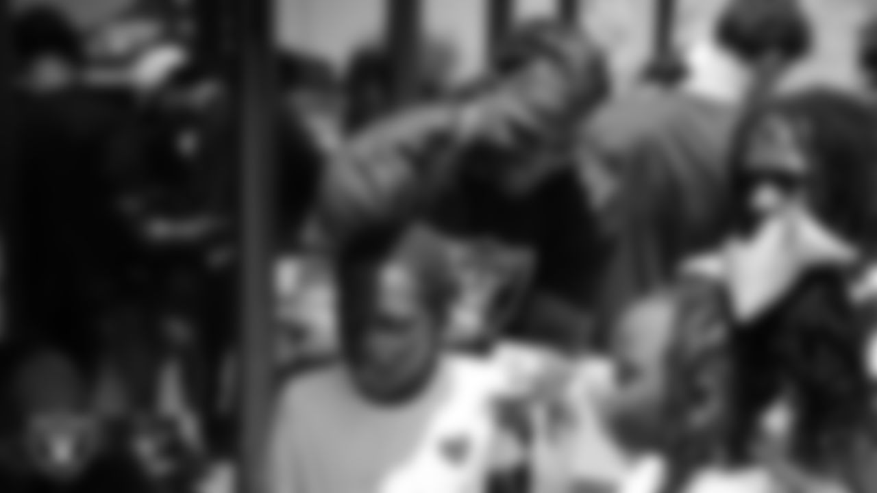 Las Vegas Raiders defensive end Jahfari Harvey (91) signs an autograph during the Raiders 4th annual Back-To-School Free Haircuts and Beautician Services event at Expertise Cosmetology Barber School.