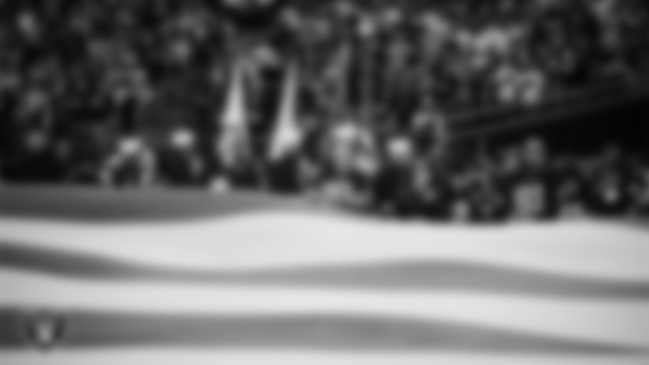 The American flag is displayed by Personal Seat License (PSL) holders on the field during the national anthem before the Las Vegas Raiders' regular season home game against the Cleveland Browns at Allegiant Stadium.