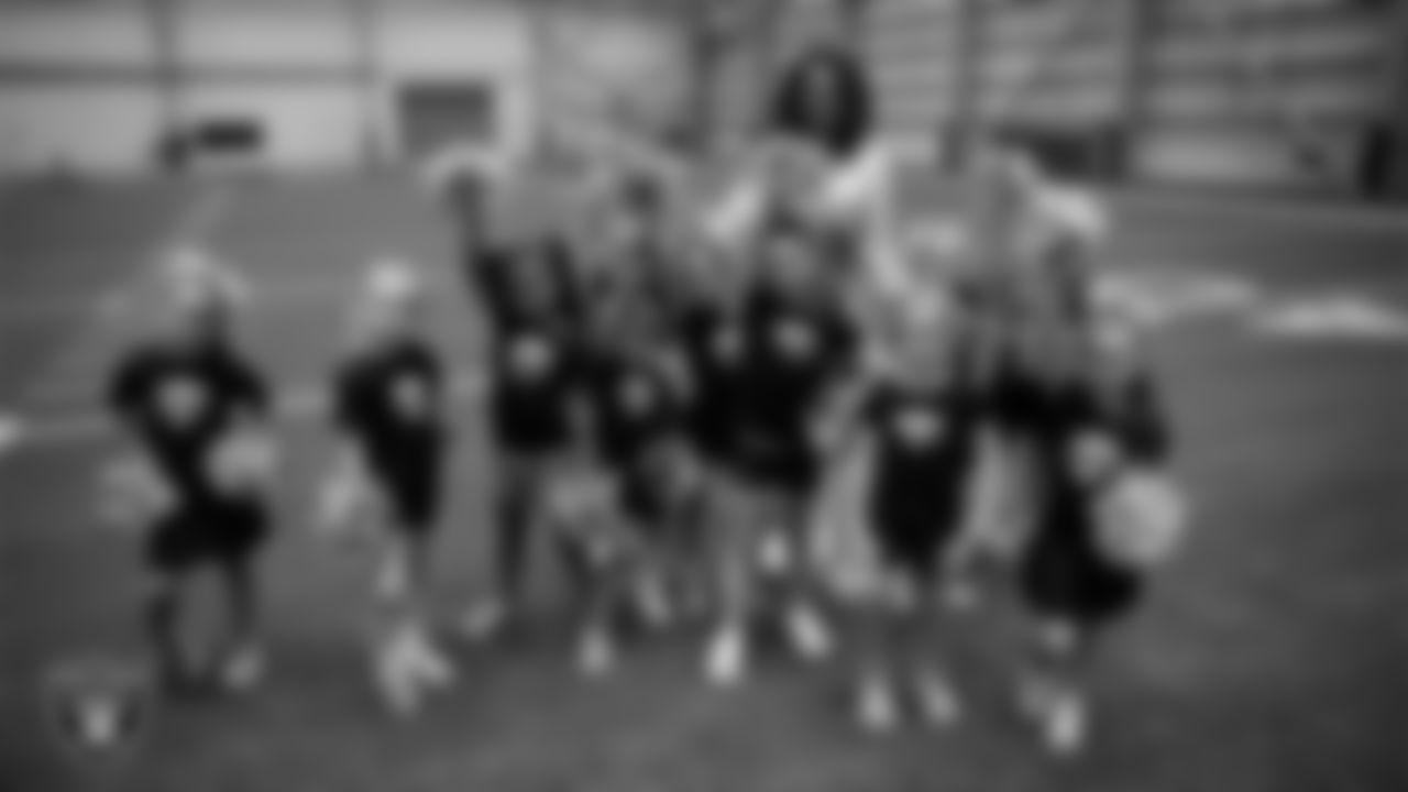 Raiderette Shayla poses with dancers during day three of summer camp at Intermountain Health Performance Center.