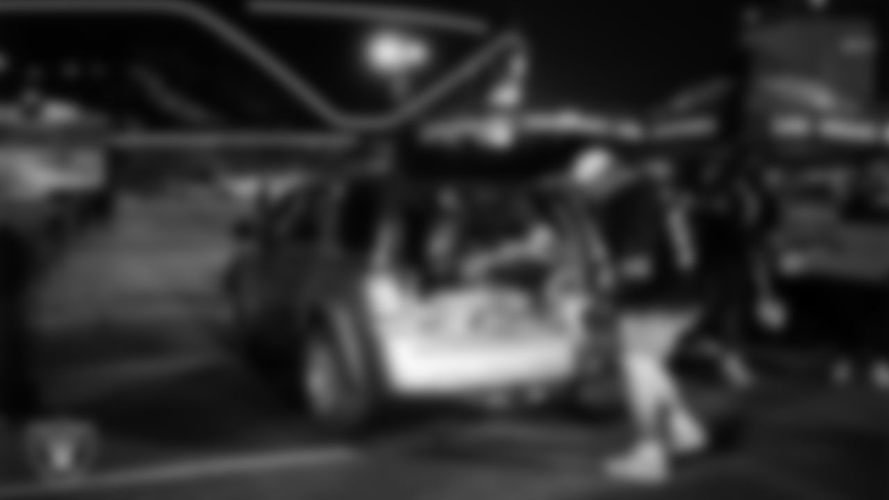 Las Vegas Raiders guard Atonio Mafi (56) helps distribute Thanksgiving meals to families during Turkey Time with the O-Line at Allegiant Stadium.