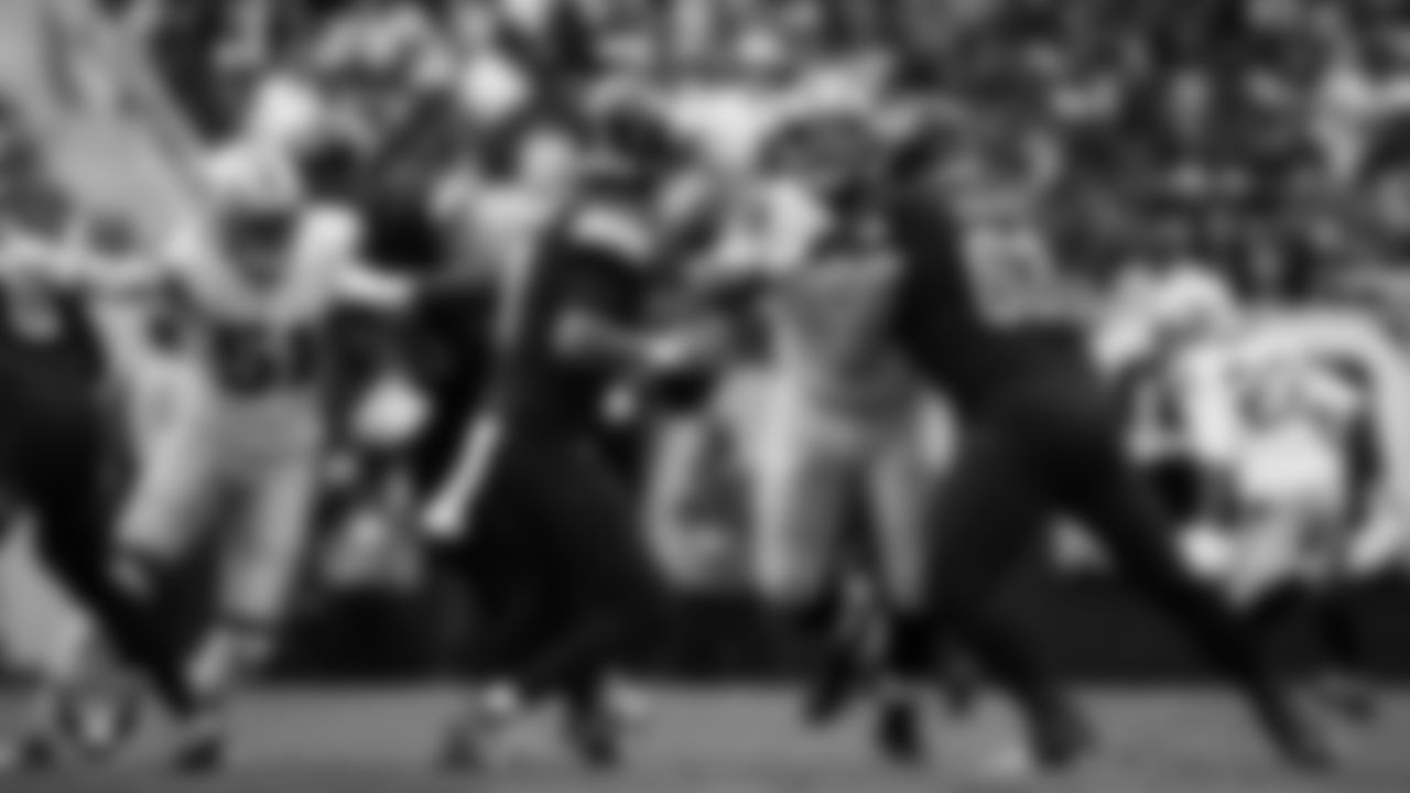 Las Vegas Raiders defensive end Malcolm Koonce (51) and defensive tackle Adam Butler (69) pressure the quarterback during the regular season away game against the Washington Commanders at Northwest Stadium.