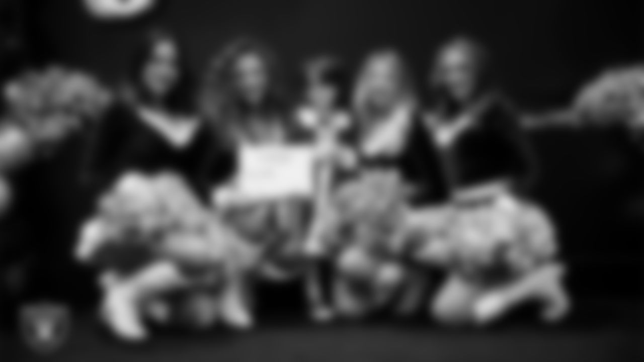 Raiderettes pose for a photo with a Junior Raiderette during the Junior Raiderettes Banquet at The Studio.