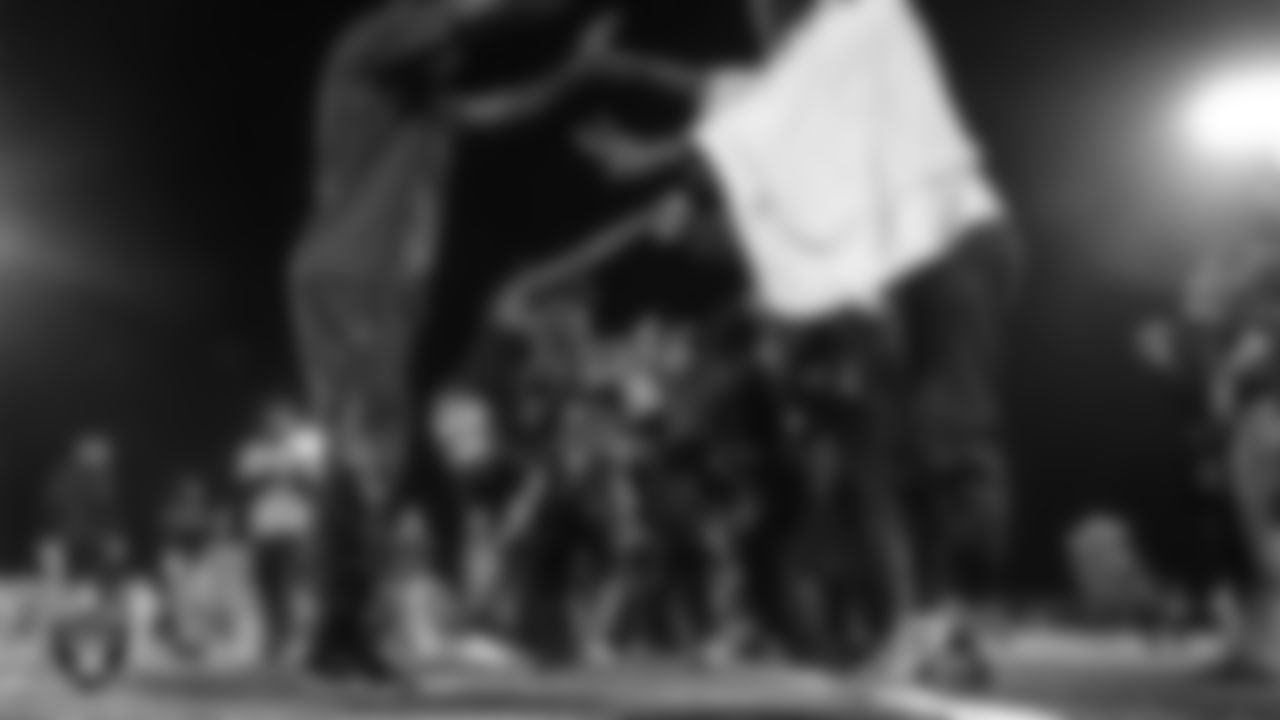 Athletes celebrate after the City of Las Vegas Silver and Black Youth Flag Football League championship game at All American Park.