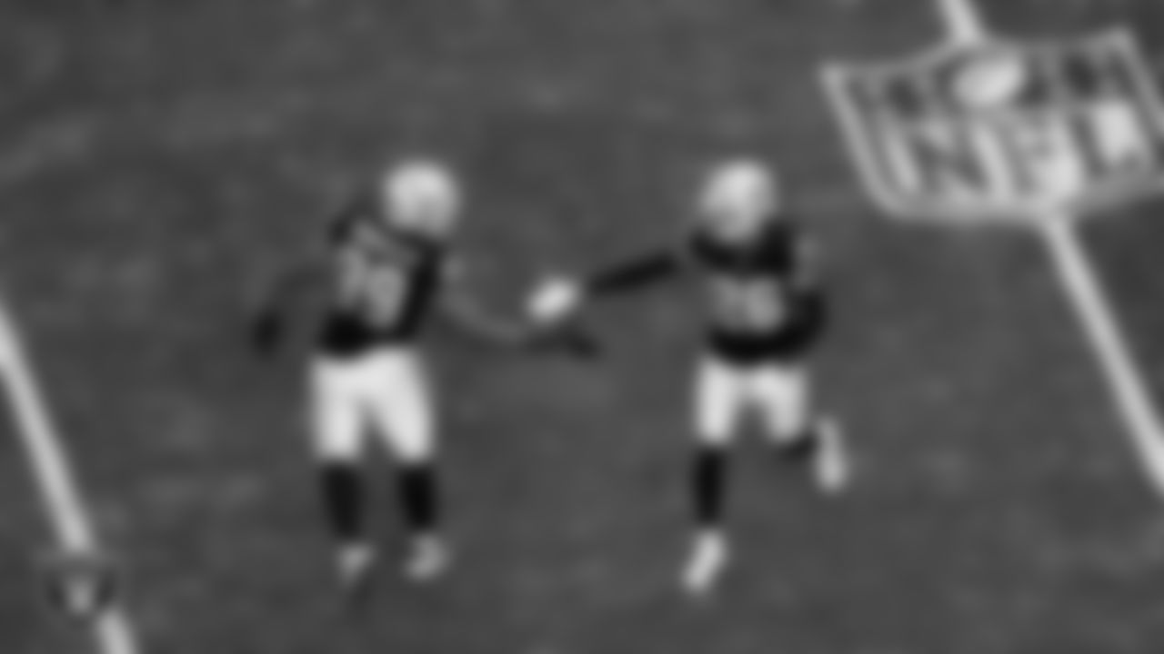 Las Vegas Raiders cornerback Darien Porter (26) celebrates with defensive tackle Thomas Booker IV (99) after breaking up a pass during the regular season home game against the Denver Broncos at Allegiant Stadium.