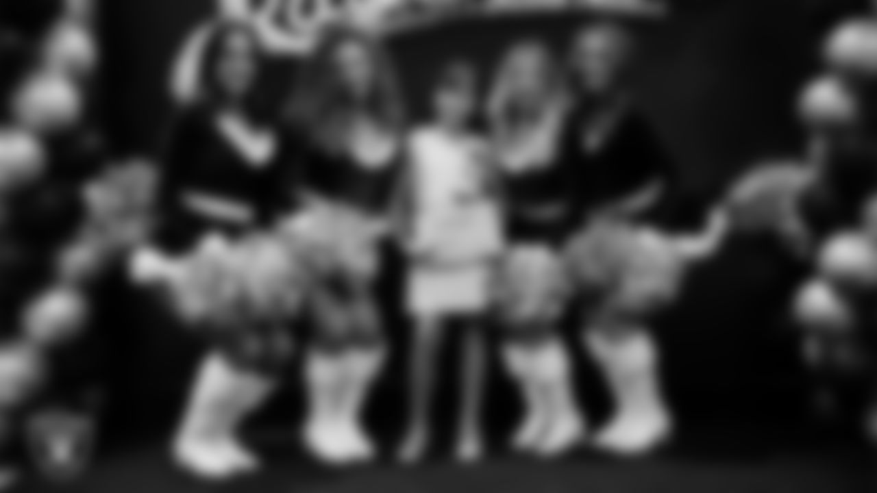 Raiderettes pose for a photo with a Junior Raiderette during the Junior Raiderettes Banquet at The Studio.