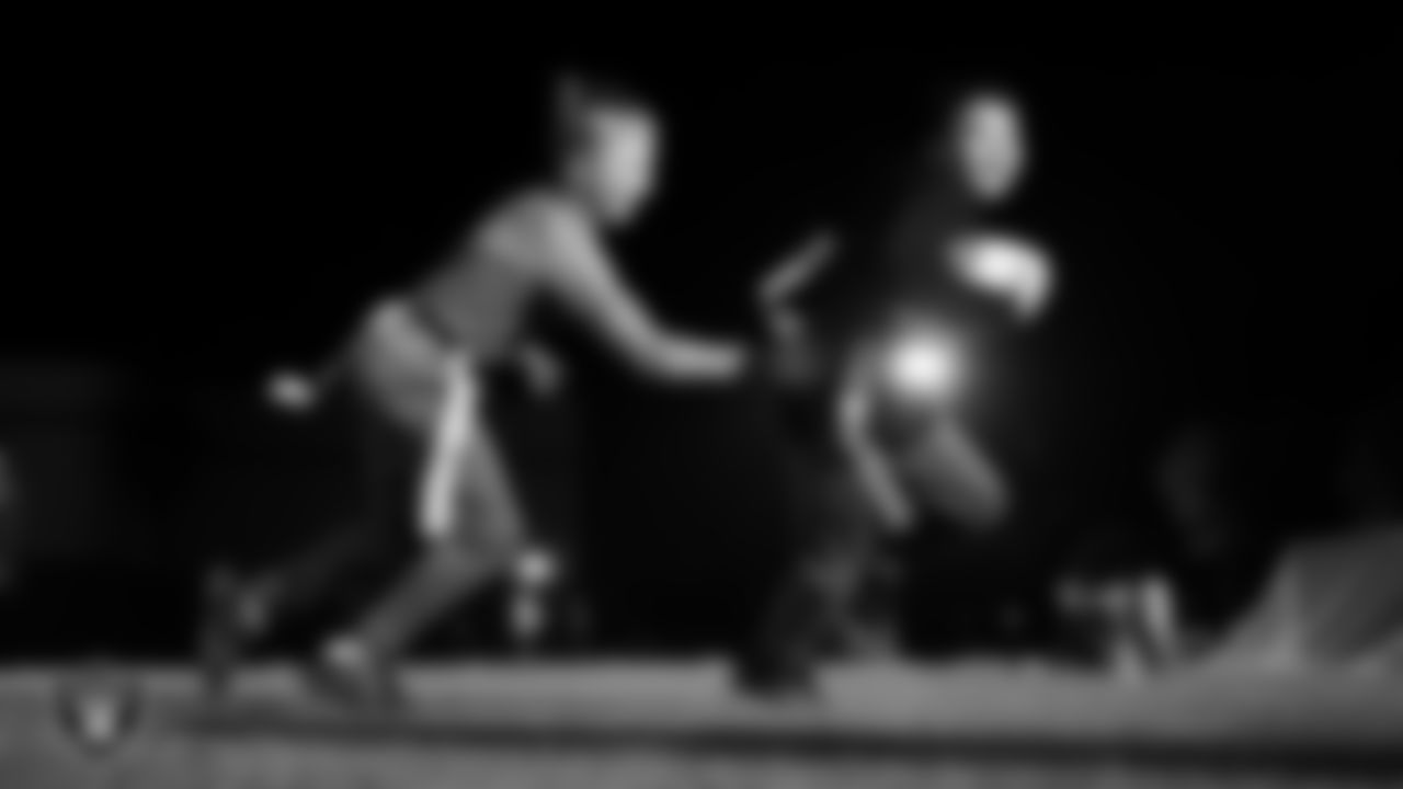 Athletes take part in a Silver and Black League flag football clinic at Bill and Lillie Heinrich YMCA.