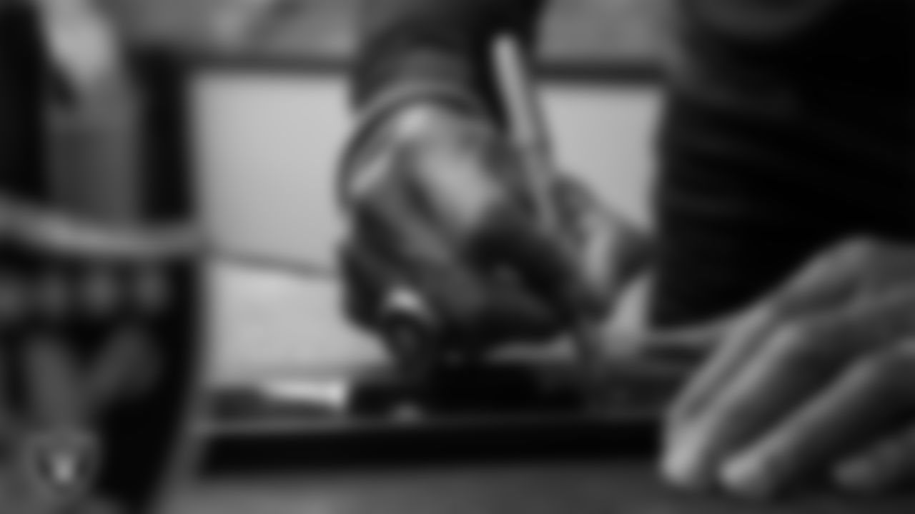 Las Vegas Raiders alumnus James Lofton signs the Al Davis Memorial torch before the Las Vegas Raiders' regular season home game against the Cleveland Browns at Allegiant Stadium.