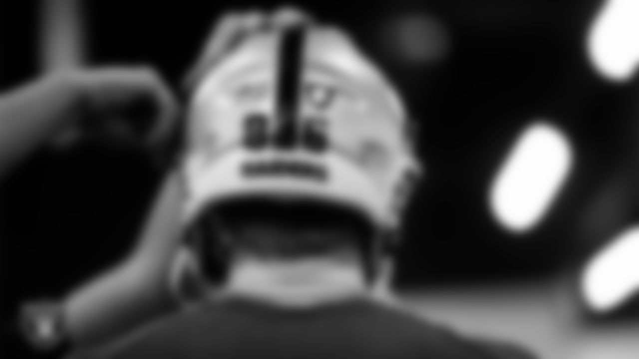 Las Vegas Raiders tight end Pat Conroy (86) tries on a helmet in the equipment room at Intermountain Health Performance Center before the start of 2025 Rookie Minicamp.