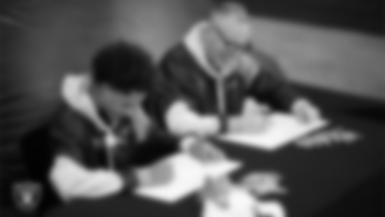 Intermountain Health Regional President Mitch Cloward designs custom shoes for My Cause My Cleats with Intermountain Children's Health patient Aiden at Intermountain Health Performance Center.