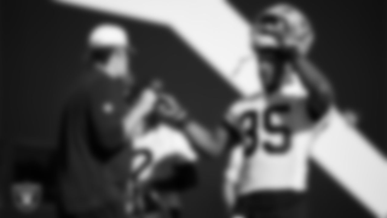 Las Vegas Raiders run game coordinator/offensive line coach Brennan Carroll and running back Chris Collier (35) during practice at Intermountain Health Performance Center.