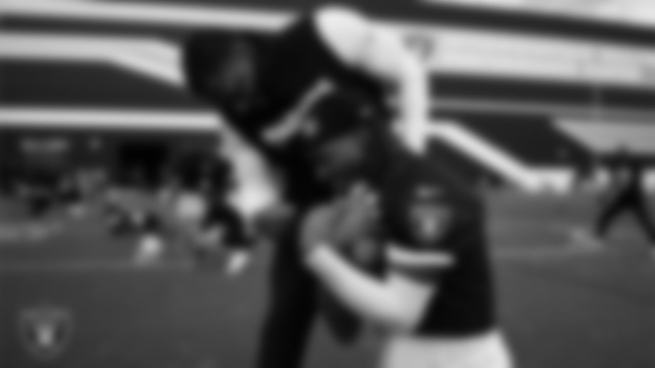 Las Vegas Raiders defensive assistant/linebackers coach Ty McKenzie and wide receiver Dont'e Thornton Jr. (10) during practice at Intermountain Health Performance Center.