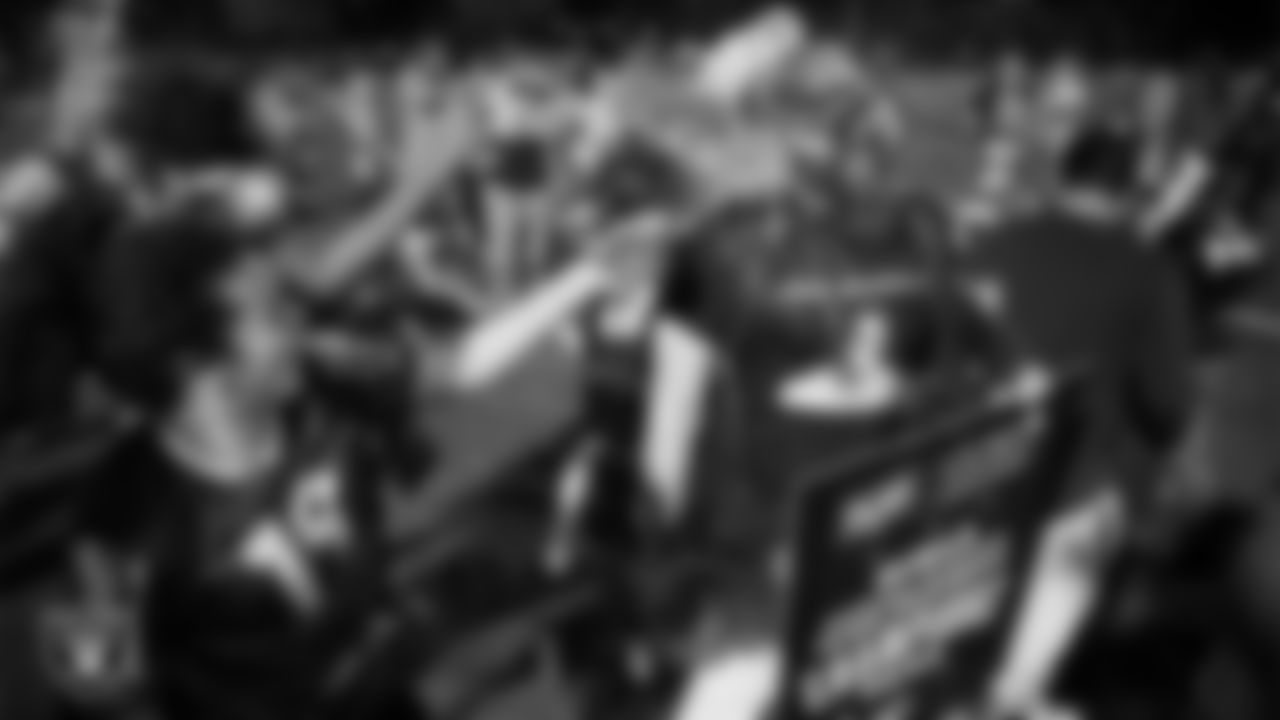 The Johnson Junior High School girls flag football team celebrates with their coach after winning a 2025 Middle School Flag Football Championship game at All American Park.