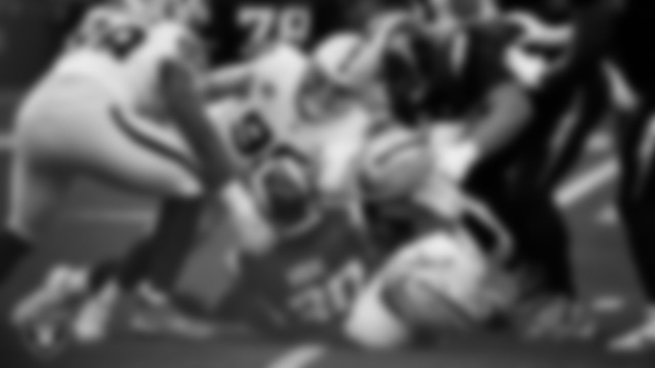 Las Vegas Raiders defensive tackle Thomas Booker IV (99), defensive end Maxx Crosby (98) and linebacker Elandon Roberts (52) make a tackle during the regular season away game against the Los Angeles Chargers at SoFi Stadium.