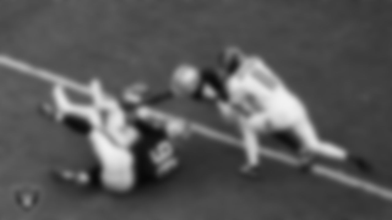 Las Vegas Raiders defensive tackle Jonah Laulu (96) makes a tackle during the regular season home game against the Tennessee Titans at Allegiant Stadium.