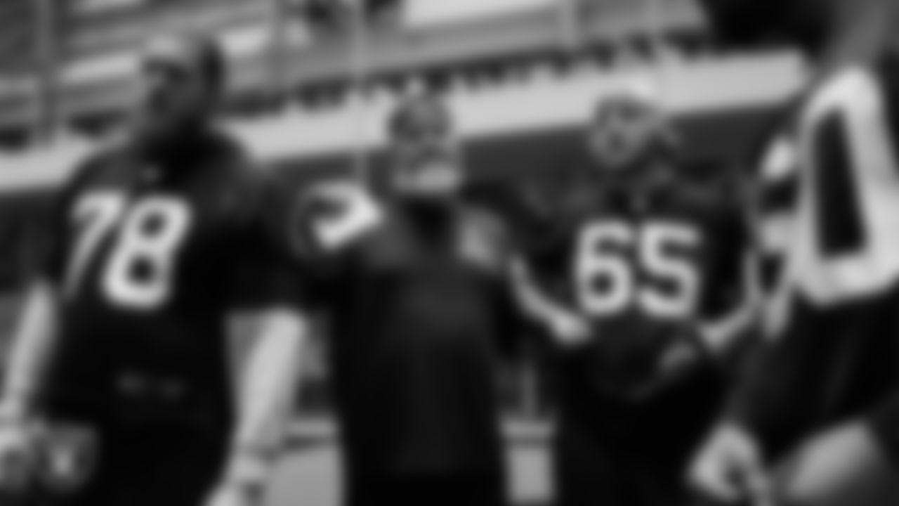 Las Vegas Raiders tackle Dalton Wagner (78), run game coordinator/offensive line coach Brennan Carroll and guard Alex Cappa (65) during practice at Intermountain Health Performance Center.