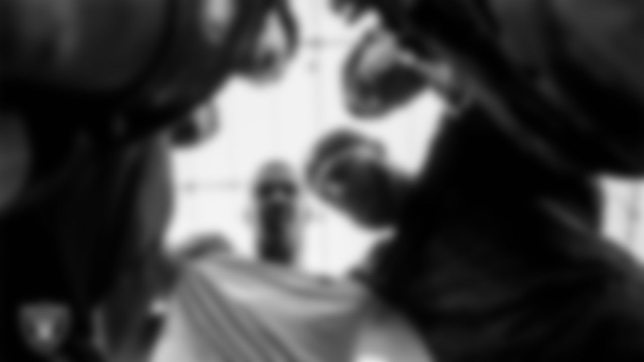 The Las Vegas Raiders defensive line huddles before the regular season home game against the Denver Broncos at Allegiant Stadium.