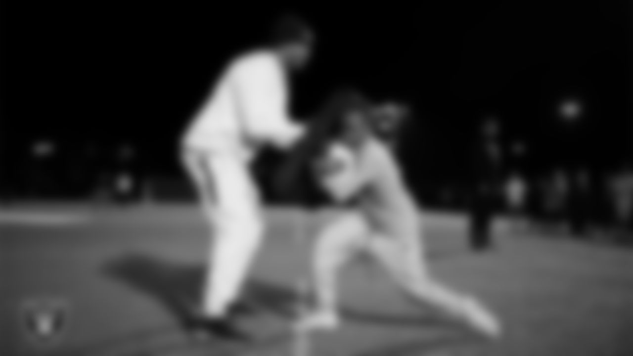An athlete takes part in a Silver and Black League flag football clinic at Bill and Lillie Heinrich YMCA.