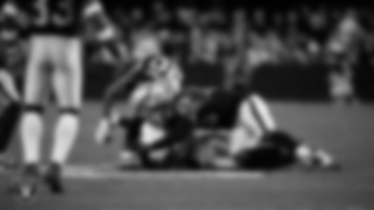 Las Vegas Raiders safety Isaiah Pola-Mao (20) and linebacker Devin White (45) make a tackle during the regular season home game against the Dallas Cowboys at Allegiant Stadium.