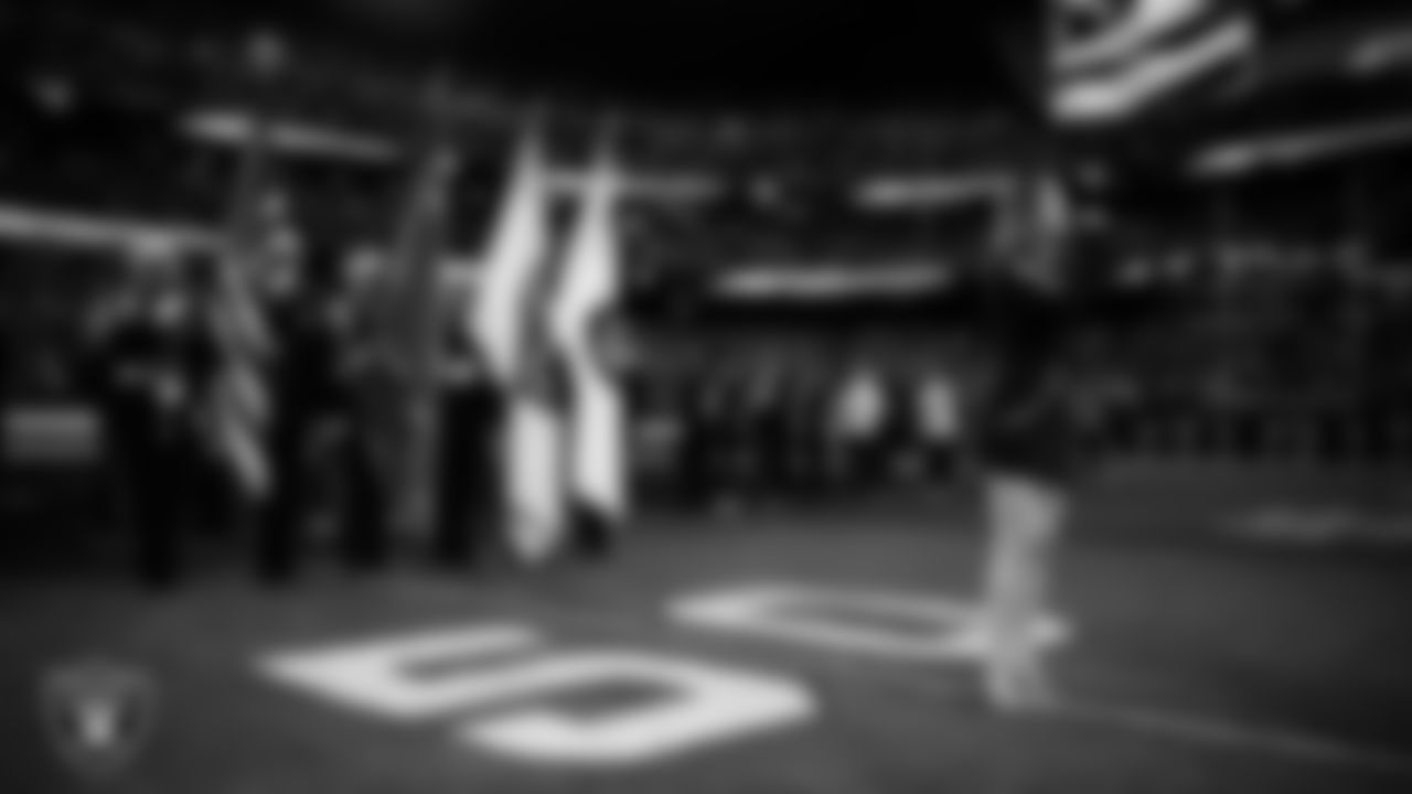 Singer Cassadee Pope performs the national anthem while the Clark County Fire Department Honor Guard presents the nation's colors before the Las Vegas Raiders' regular season home game against the Cleveland Browns at Allegiant Stadium.